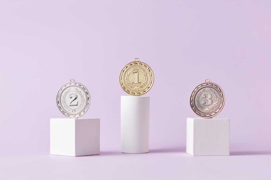 Medals on a podium against a soft pastel background, ideal for awards themes.